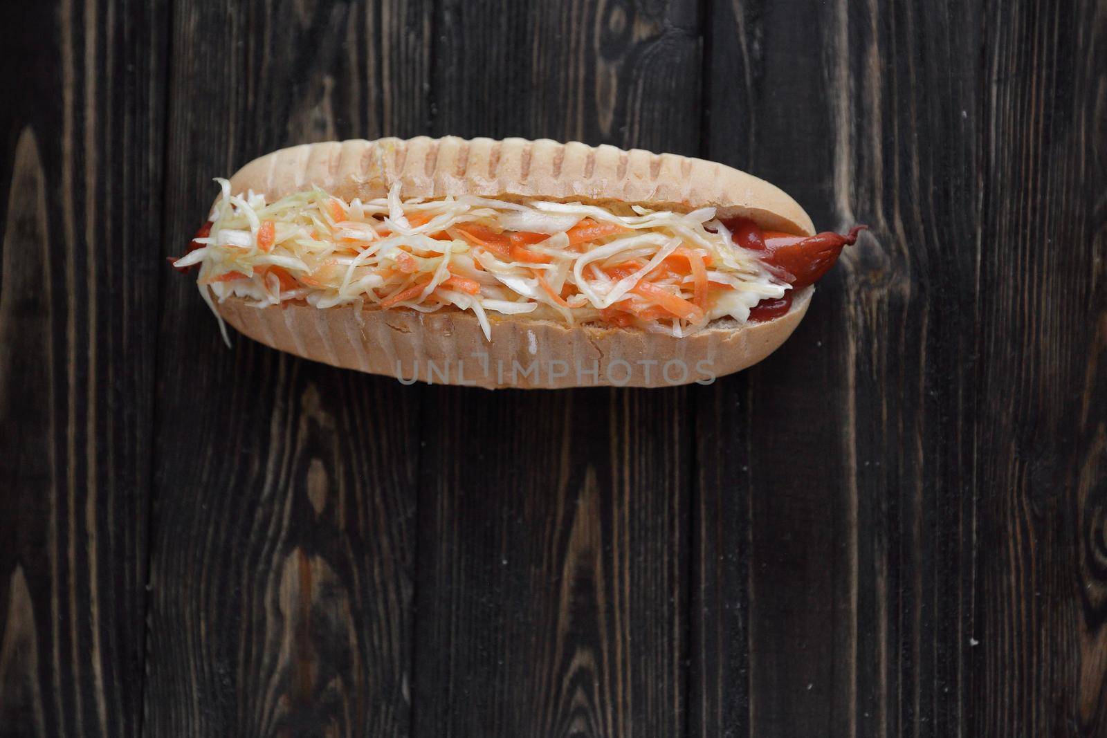 hot dog with vegetables on wooden background.photo with copy space by SmartPhotoLab