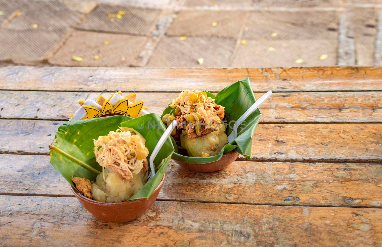 Vigorón with leaves served on a wooden table, two vigorones served on wooden background, vigorón typical food from nicaragua