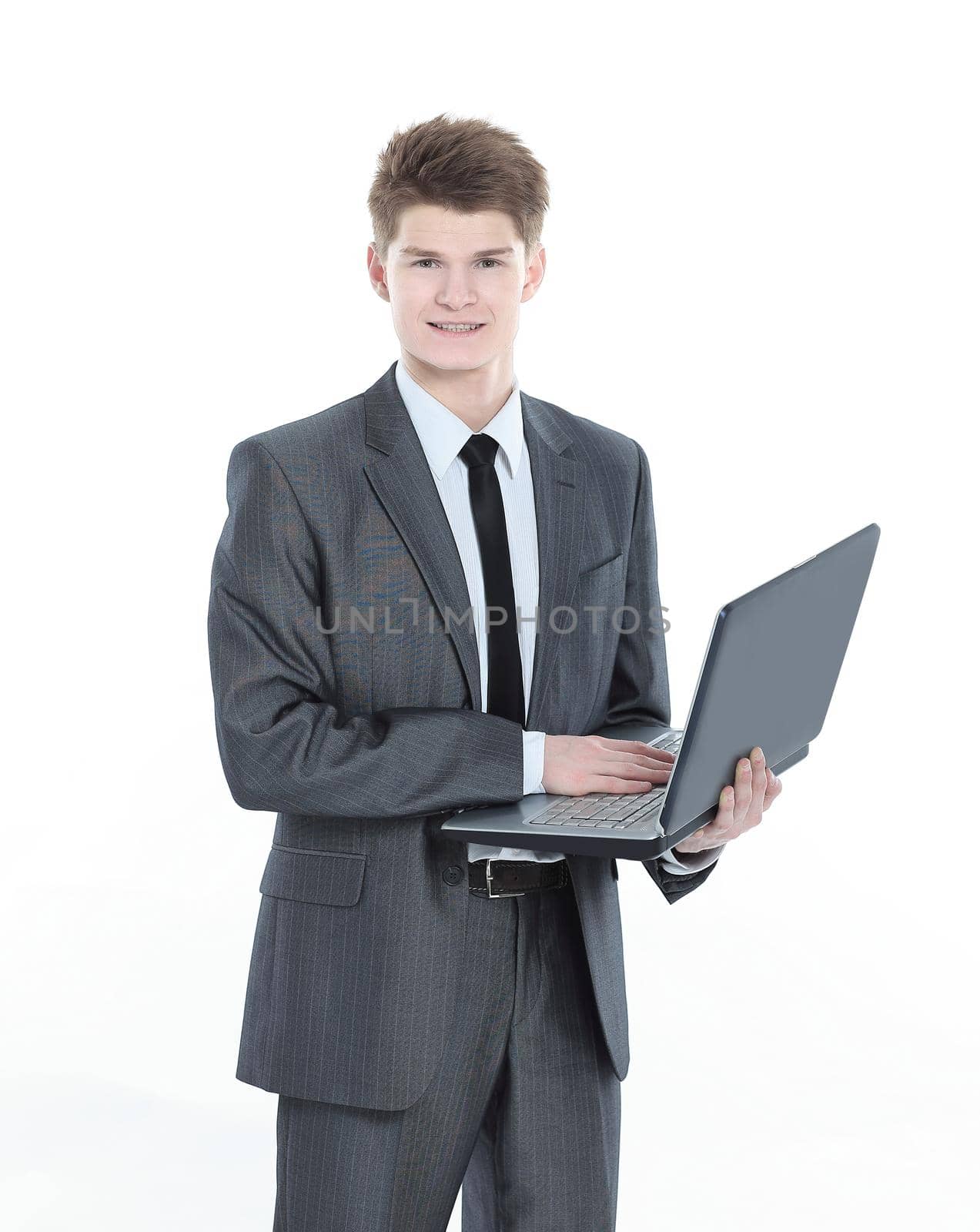 confident young businessman with a laptop .isolated on a white background.