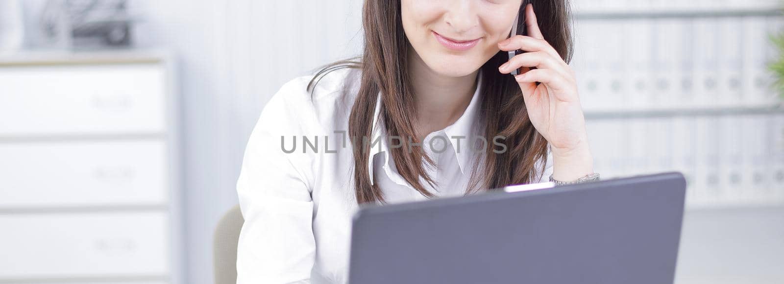 closeup. business woman talking on mobile phone by SmartPhotoLab