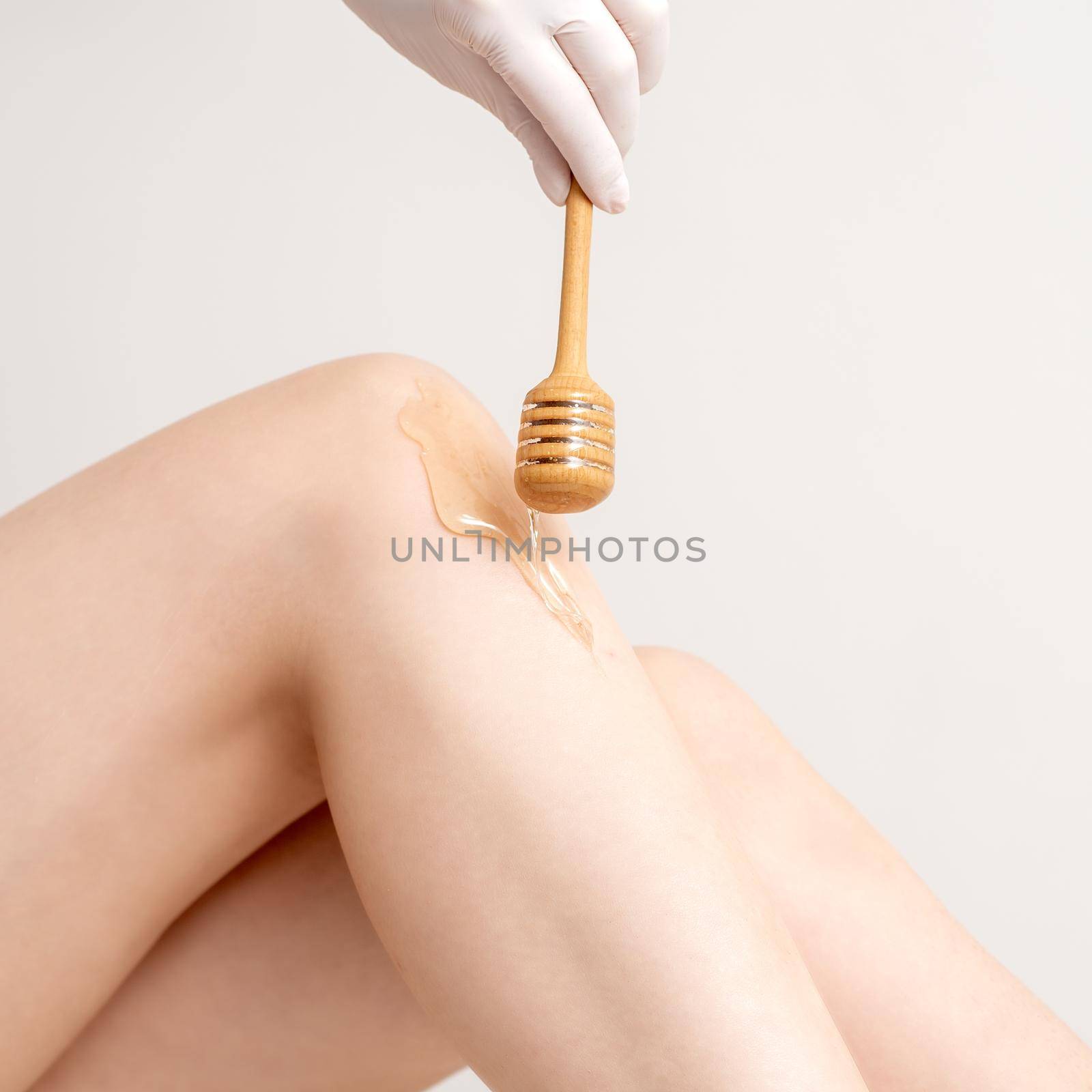 Wax flowing down on female leg by okskukuruza