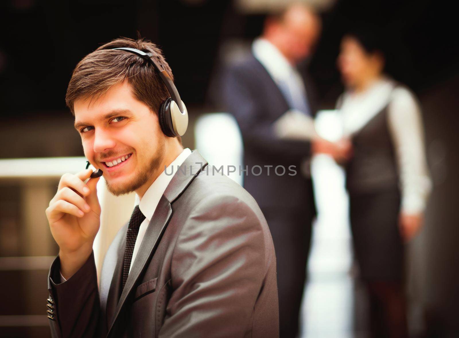 Happy young man working at callcenter, using headset by SmartPhotoLab