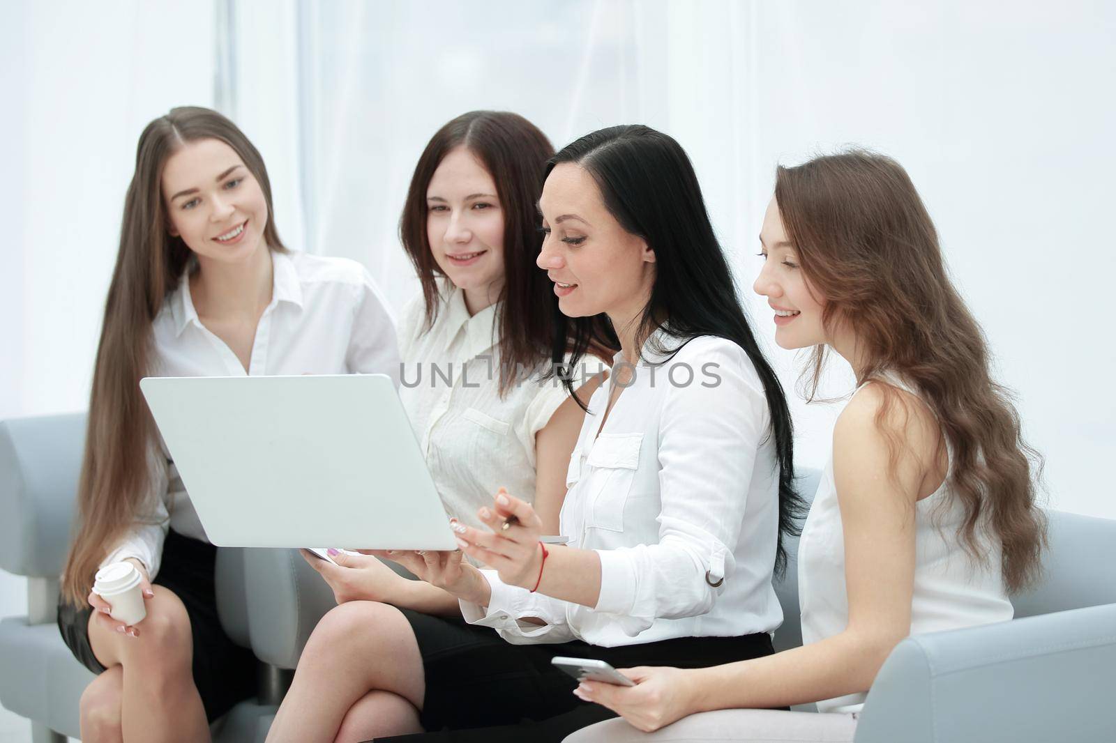 group of employees using laptop to check financial data.