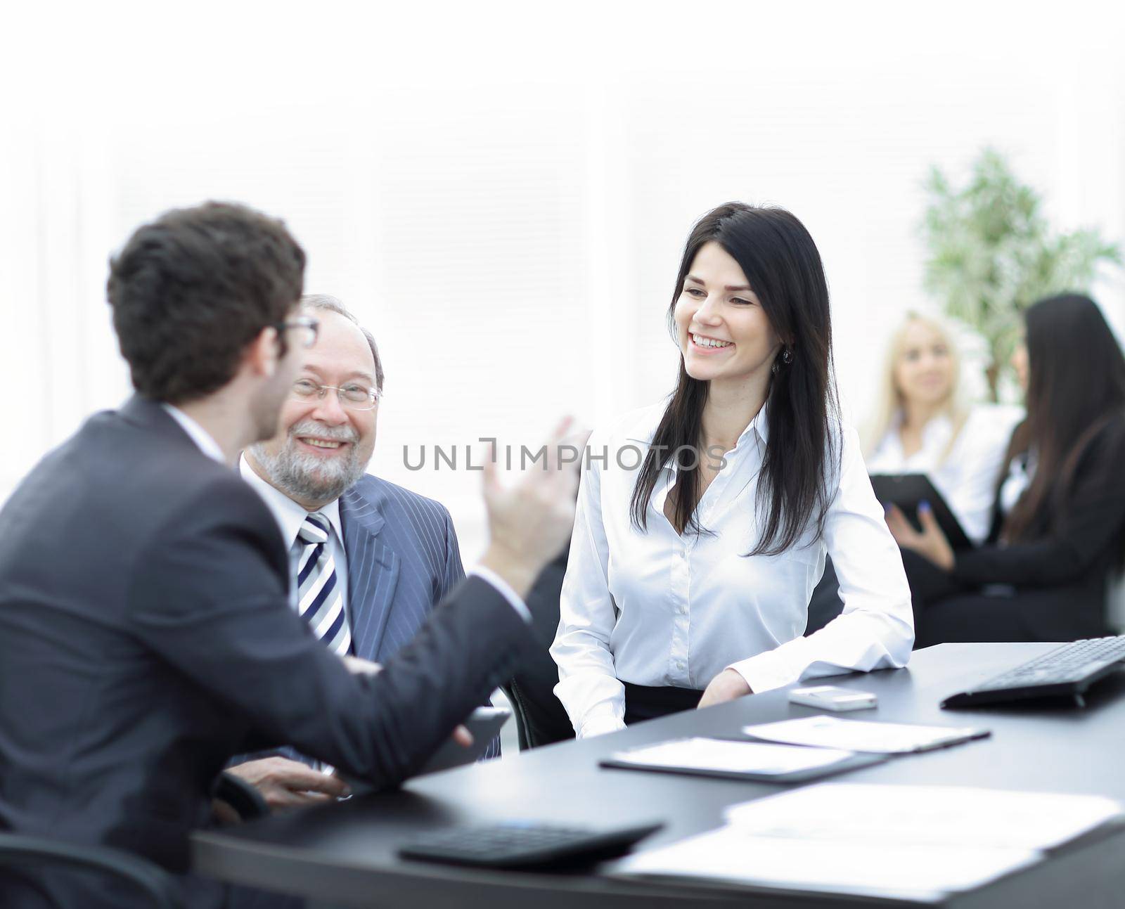 project Manager and staff talking at the Desk .teamwork