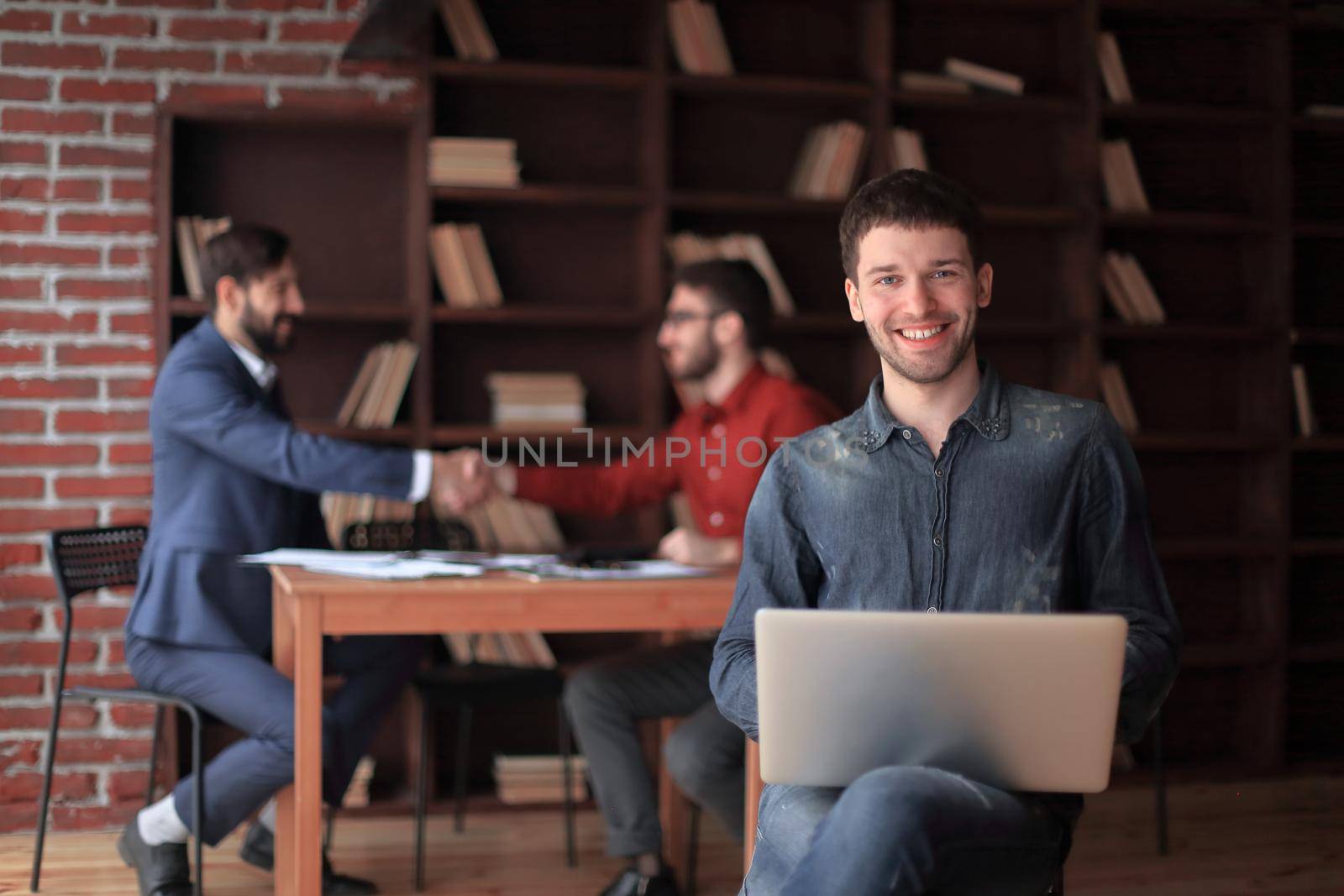 marketing Manager works on a laptop in a modern Studio.business concept