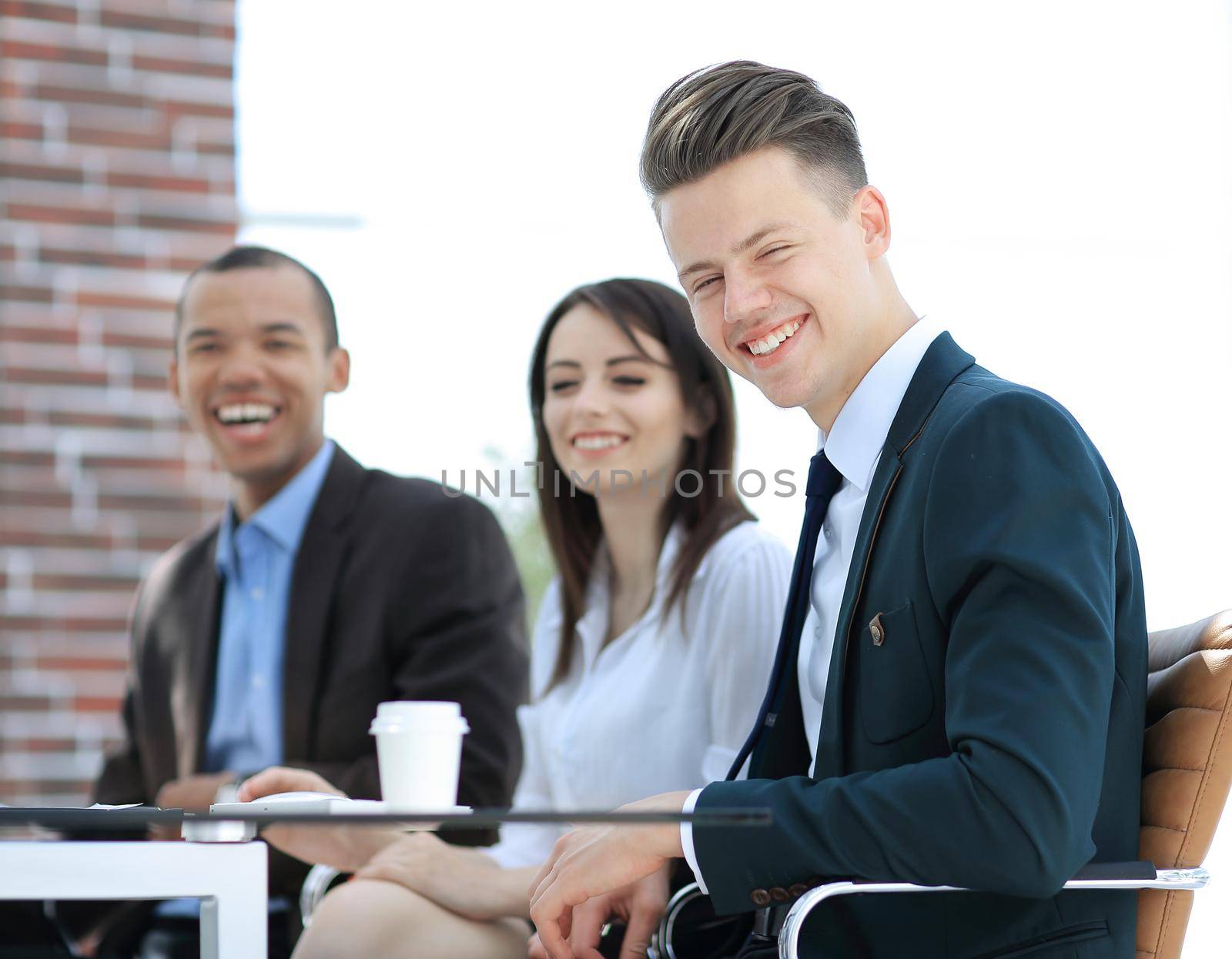 portrait of a professional business team sitting at Desk by SmartPhotoLab