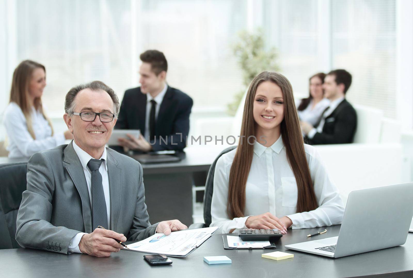 businessman and business woman checking financial statement by SmartPhotoLab