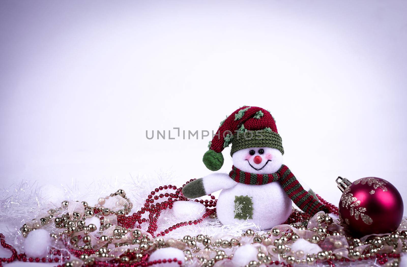 cute toy snowman and various Christmas decorations on a white background.photo with copy space