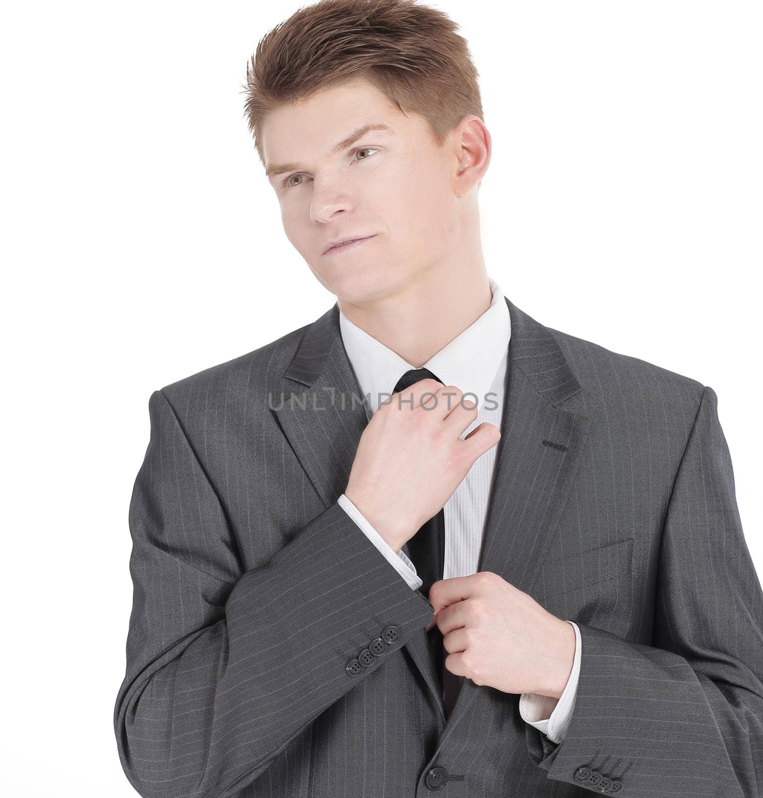 young businessman adjusting his tie.isolated on a white by SmartPhotoLab