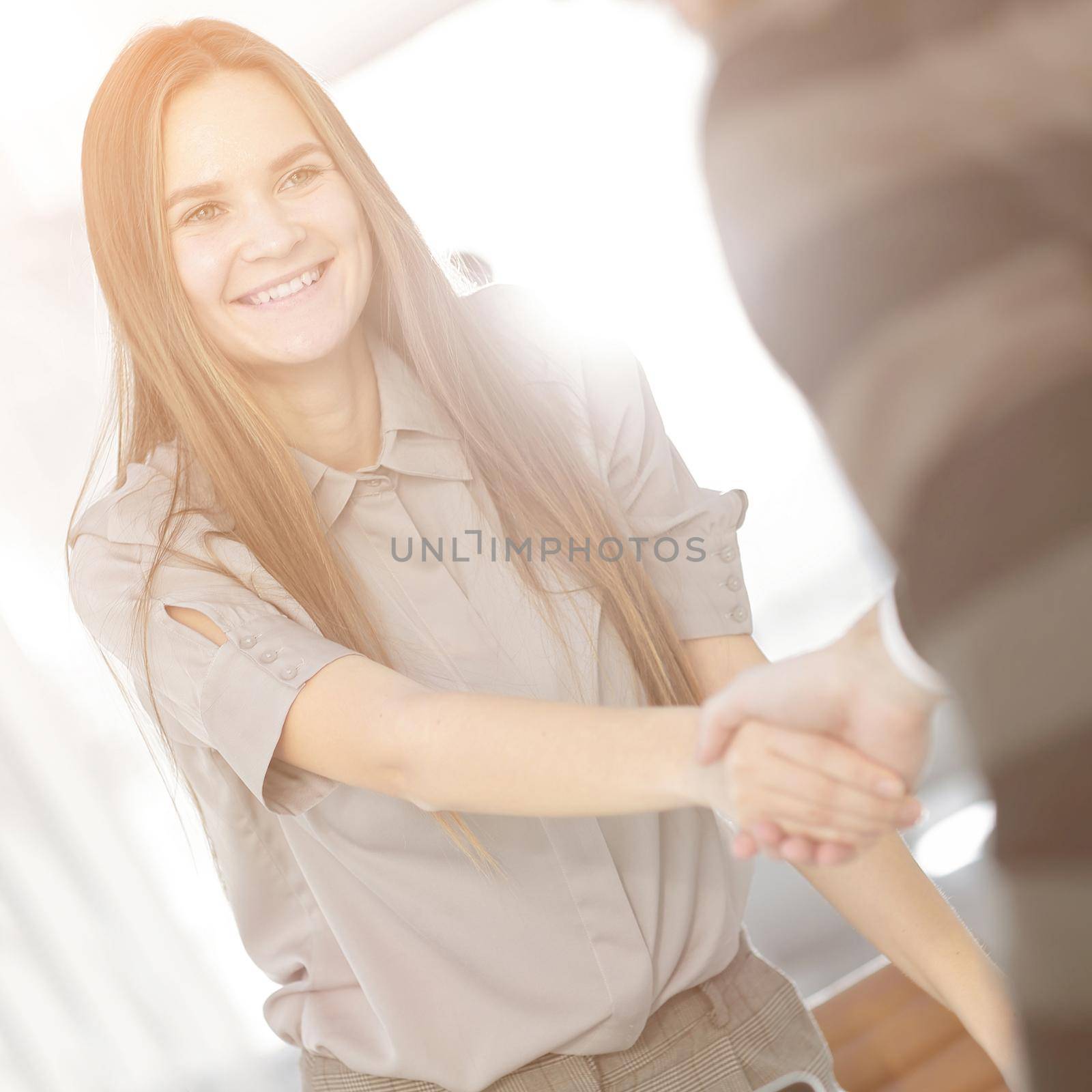 closeup. the handshake of employee and customer in a modern office