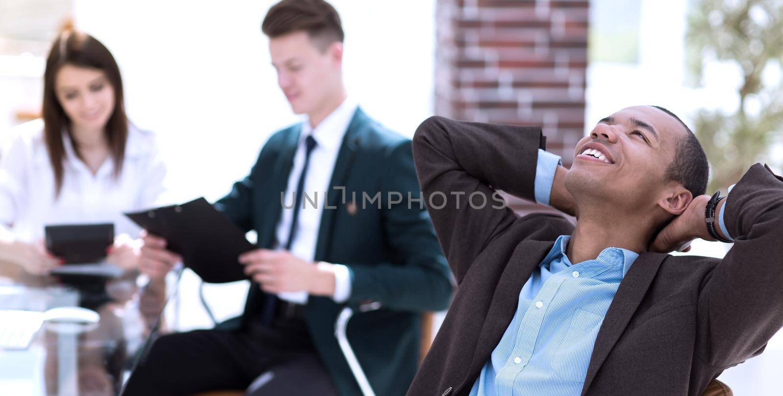 dreaming businessman on blurred background office. photo with copy space by SmartPhotoLab