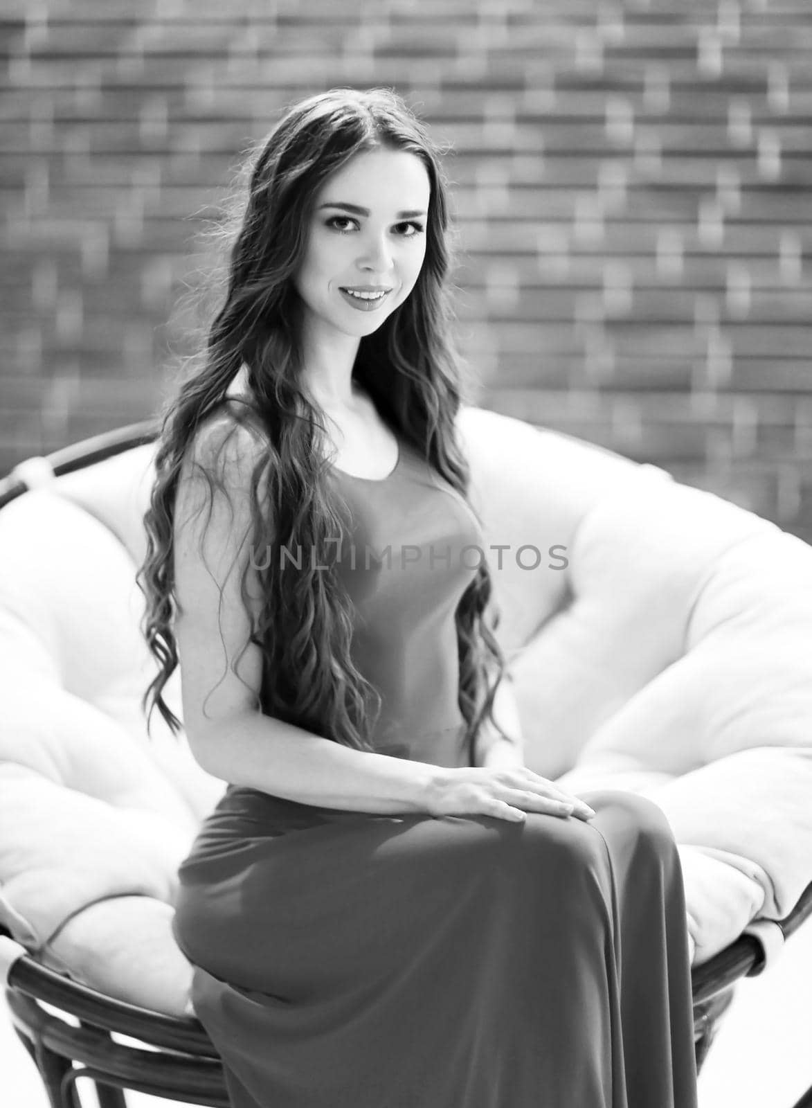 portrait of cute young woman on brick wall background.