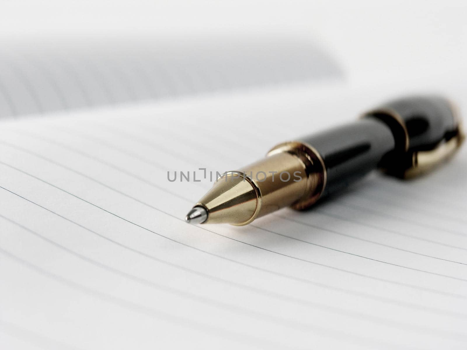 close up.stylish ballpoint pen on notebook sheet by SmartPhotoLab