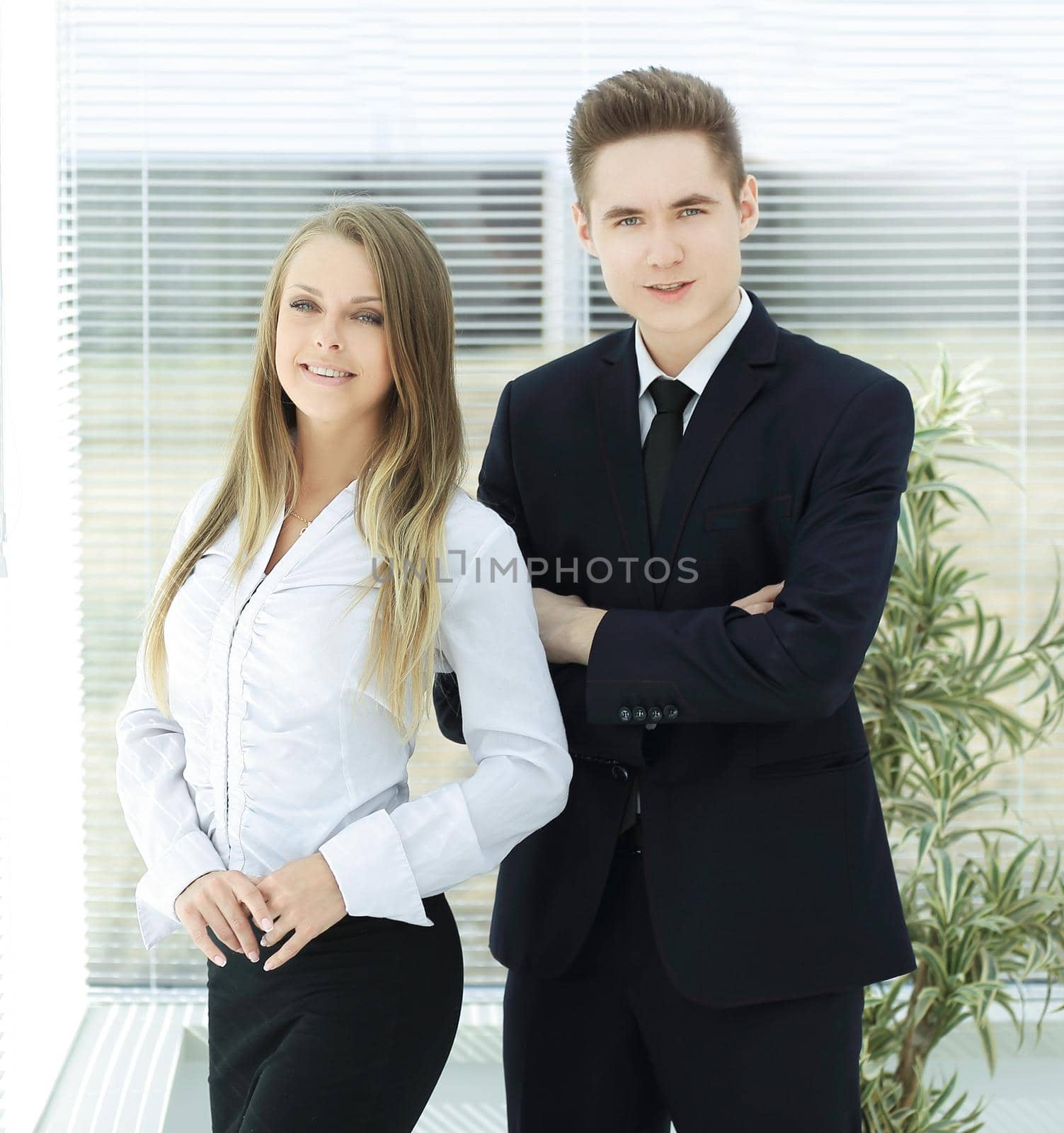 business couple standing in a modern office by SmartPhotoLab