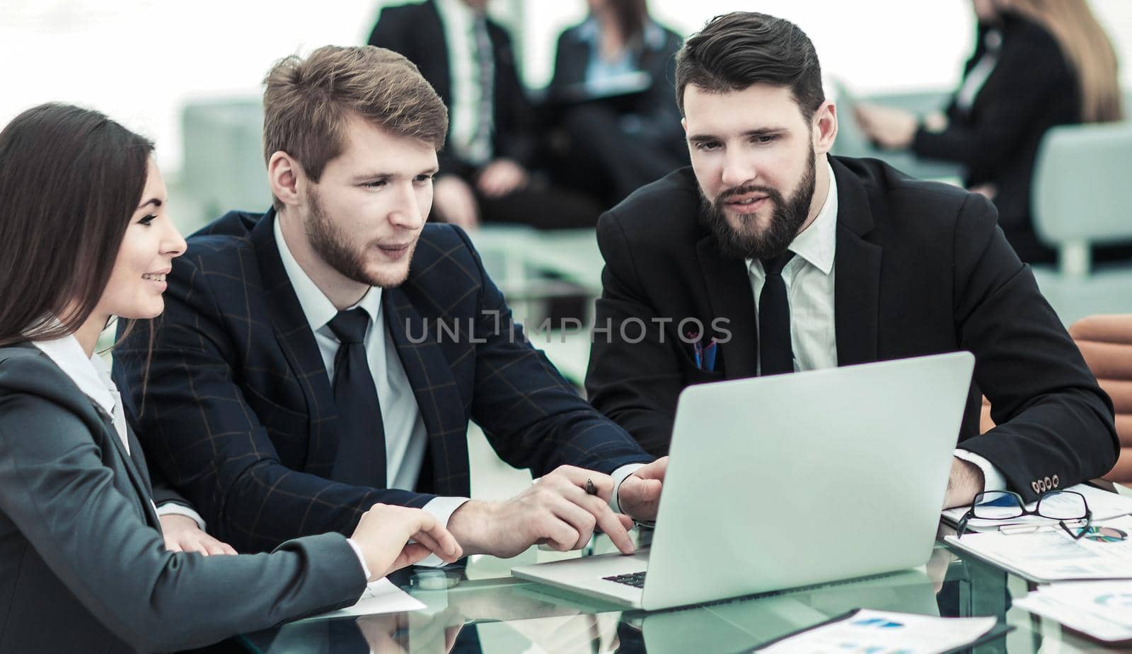 business team working on laptop with financial records in the modern office. the photo has a empty space for your text