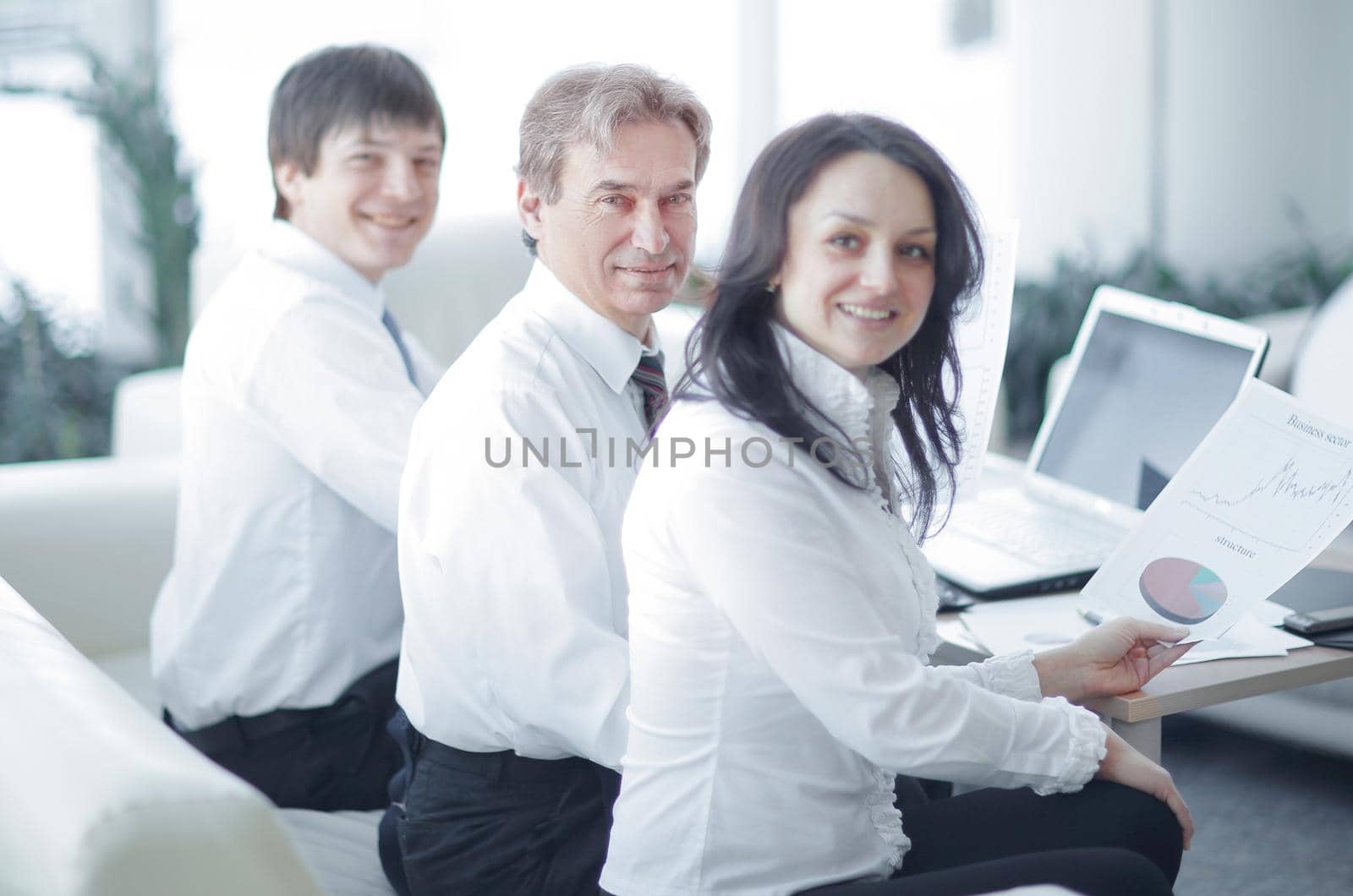 portrait of modern business woman on the background of her workplace by SmartPhotoLab