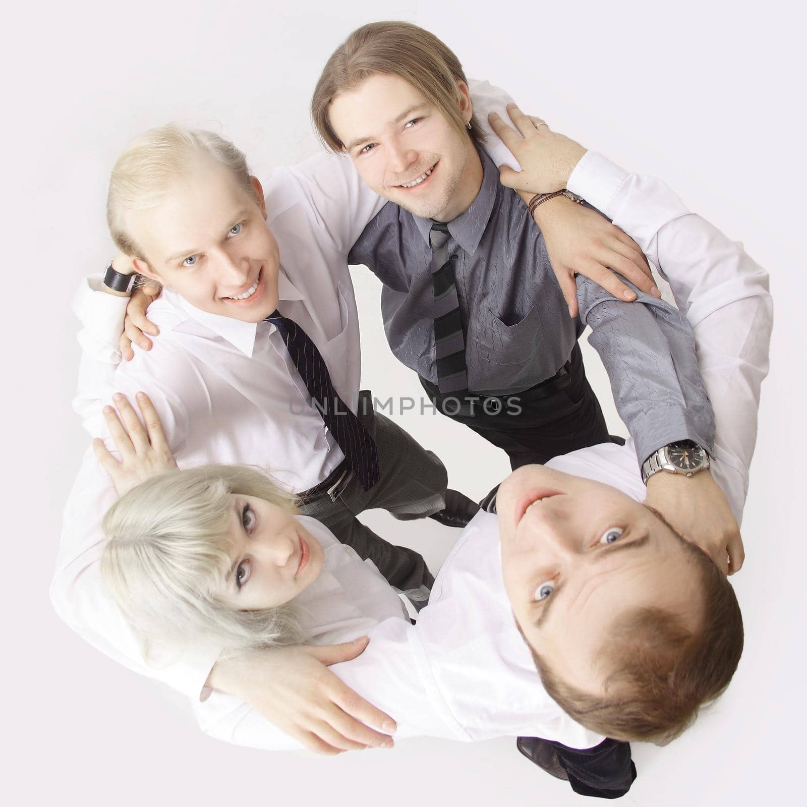 business team with arms around each other's shoulders and looking at camera by SmartPhotoLab