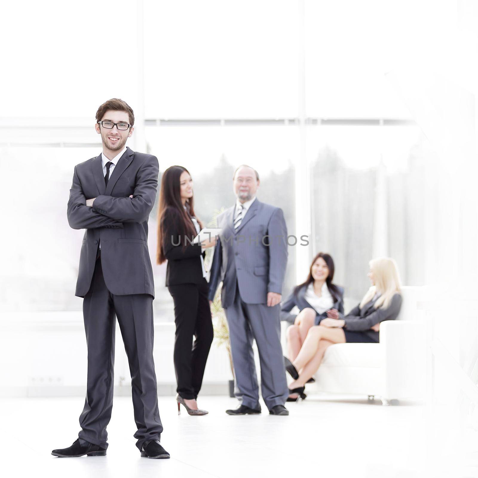 in full growth.young businessman standing in the center of the modern office. business concept