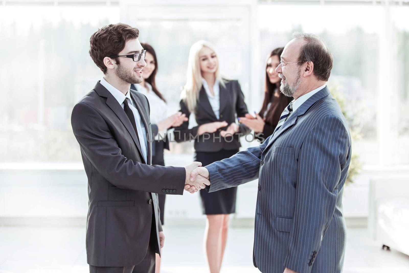 welcome and handshake of business partners in the lobby of the modern office