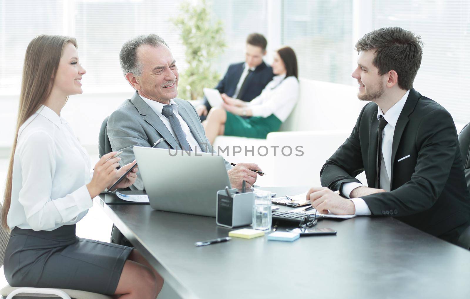 client talking with the staff at the Desk in the office by SmartPhotoLab