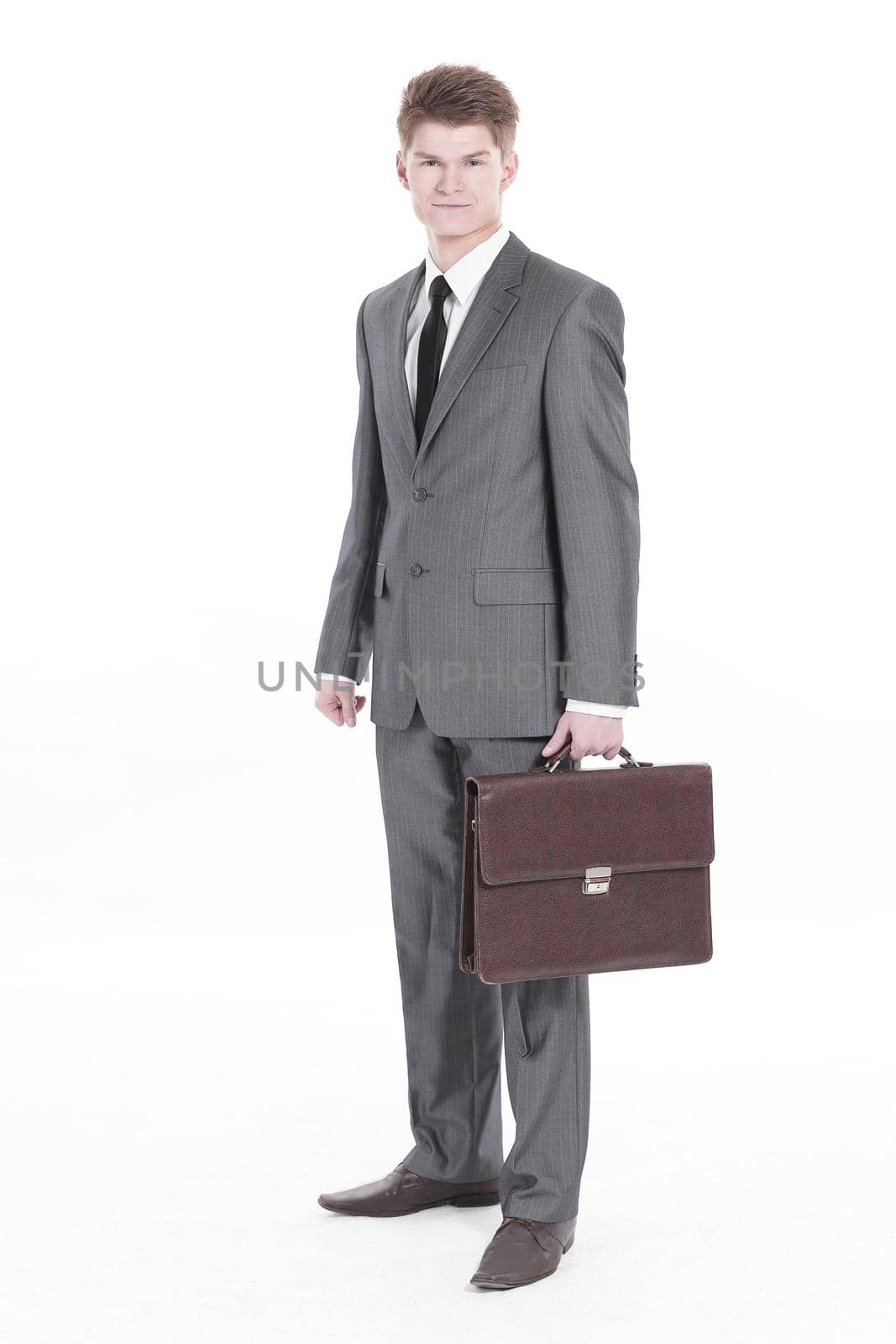 in full growth.young businessman with a leather briefcase.isolated on white background