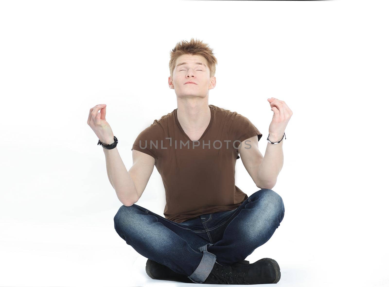 momodern guy meditates sitting on the floor.isolated on white background