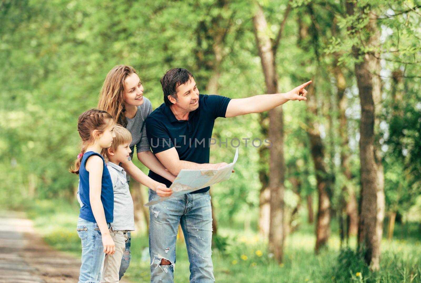 family leisure . happy family looking at maps while traveling in the Park