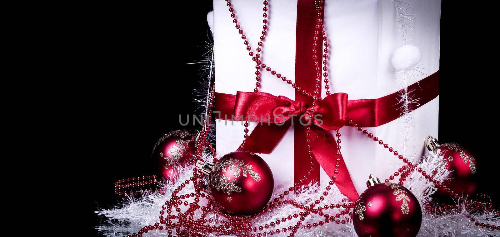 box with Christmas present and Christmas decorations on a black by SmartPhotoLab