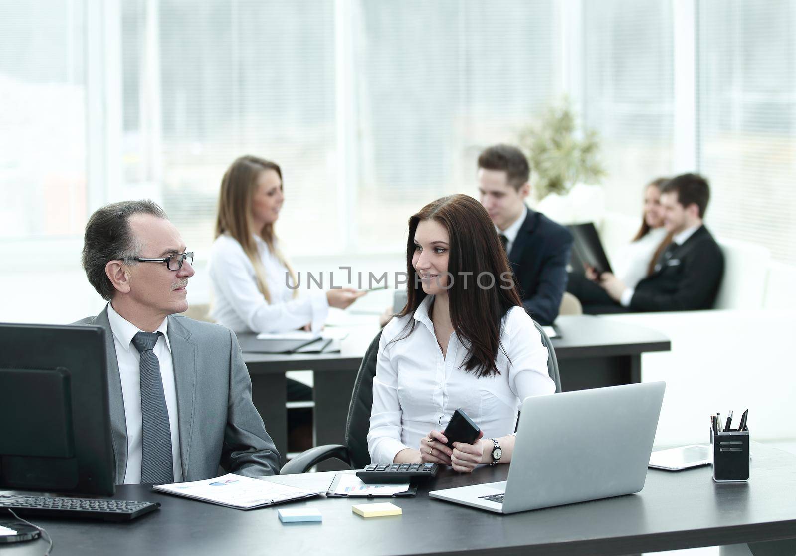 Businessman analyzing investment, budget and income charts at his workplace by SmartPhotoLab