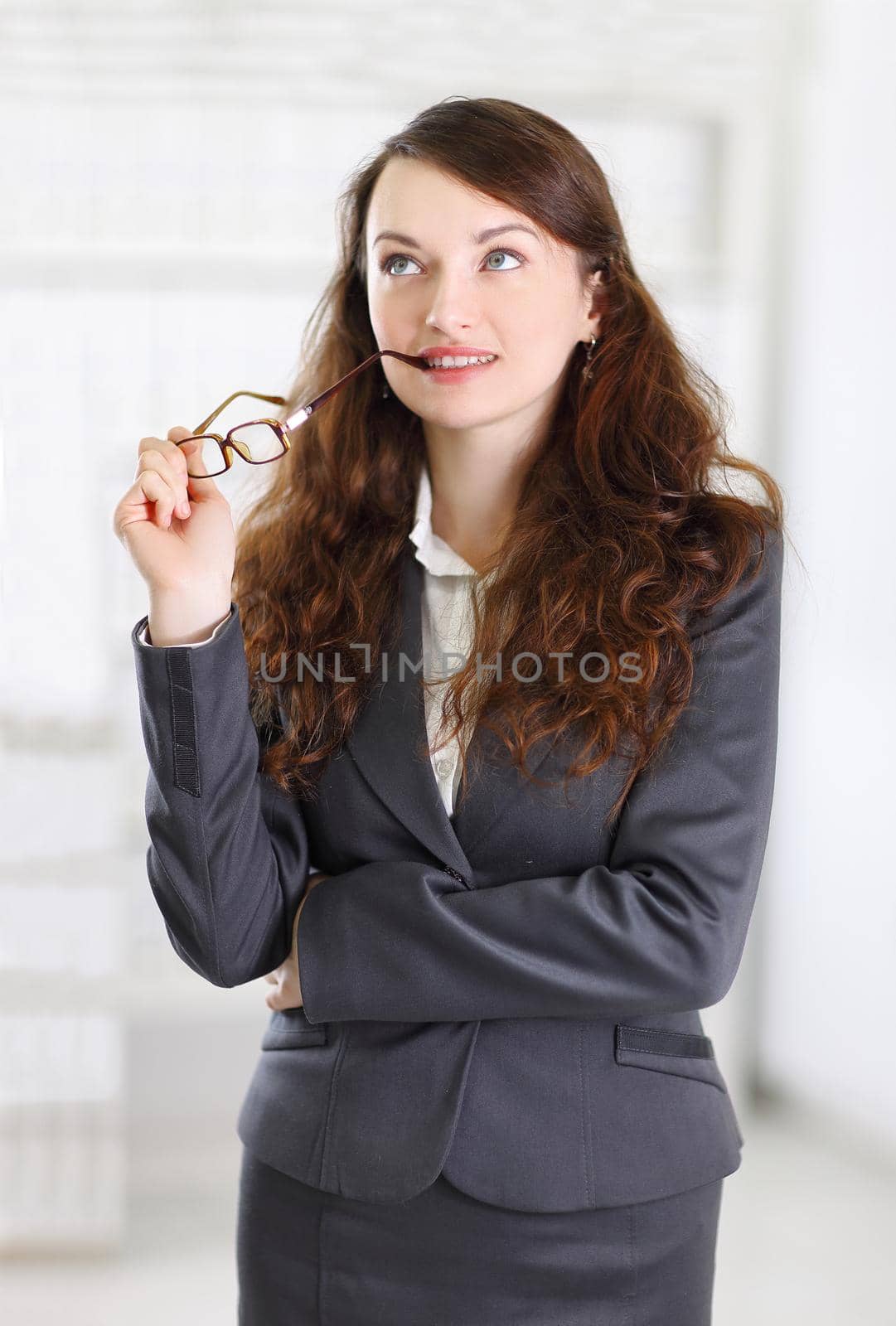 pensive business woman on blurred background office by SmartPhotoLab