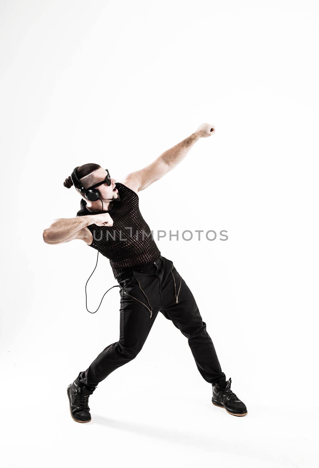 creative rapper in the headphones and dark glasses performs a rap song .photo on a white background and has an empty space for your text