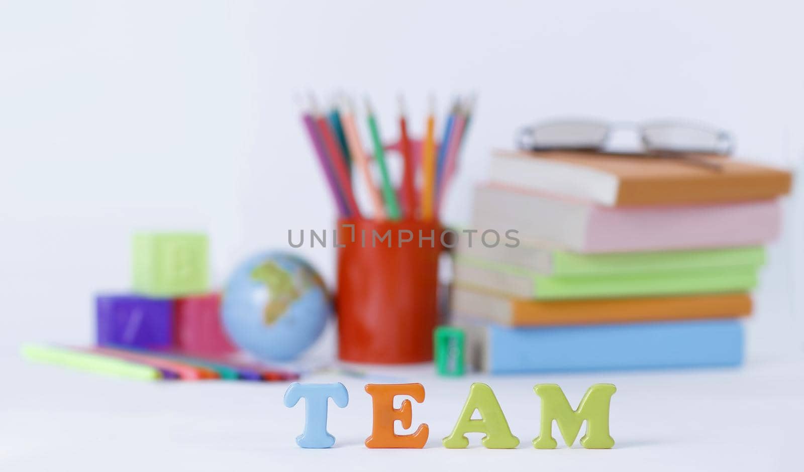 word team on blurred background of school supplies .photo with c by SmartPhotoLab