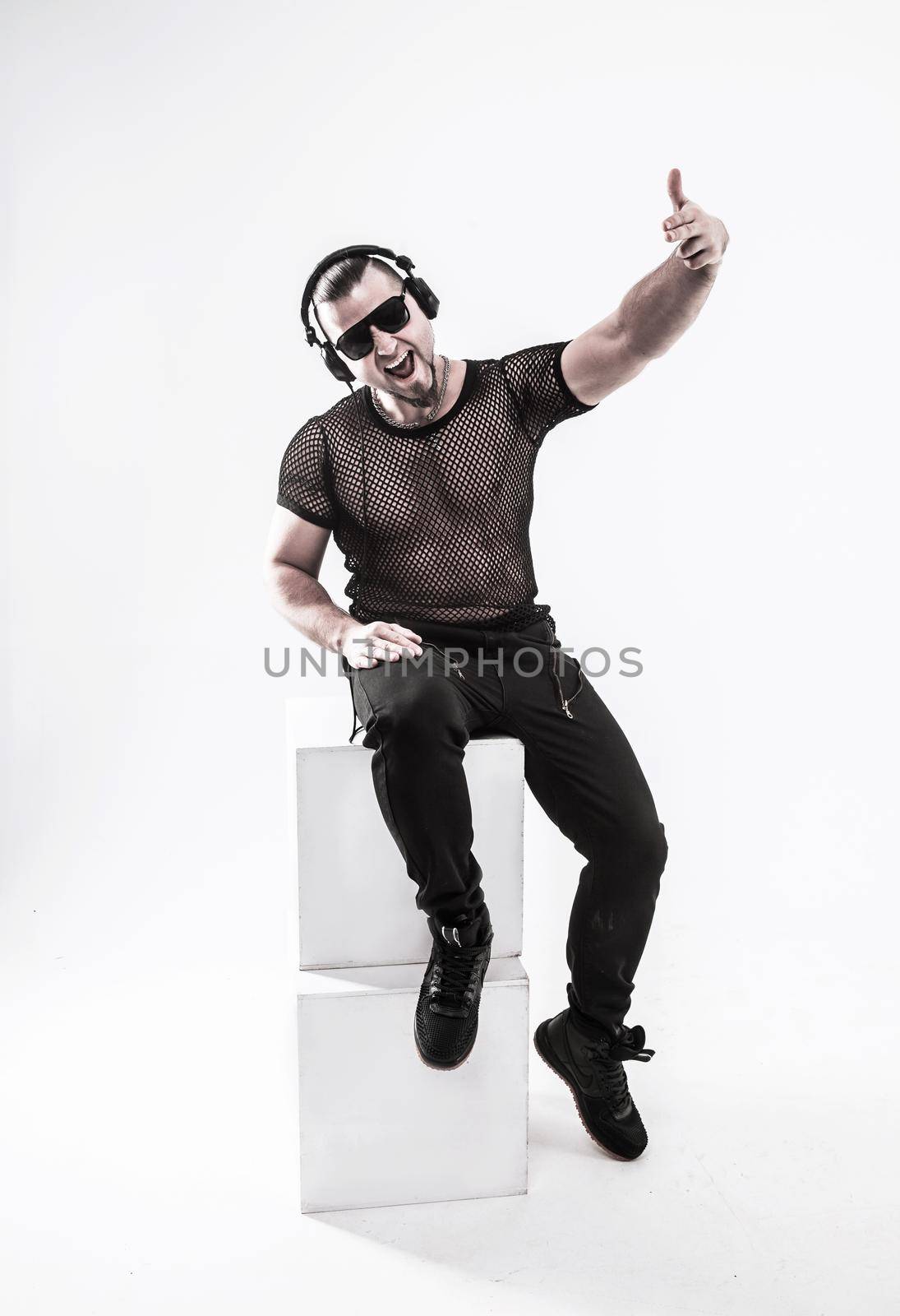 DJ - rapper in a stylish t-shirt with headphones and with hands by SmartPhotoLab