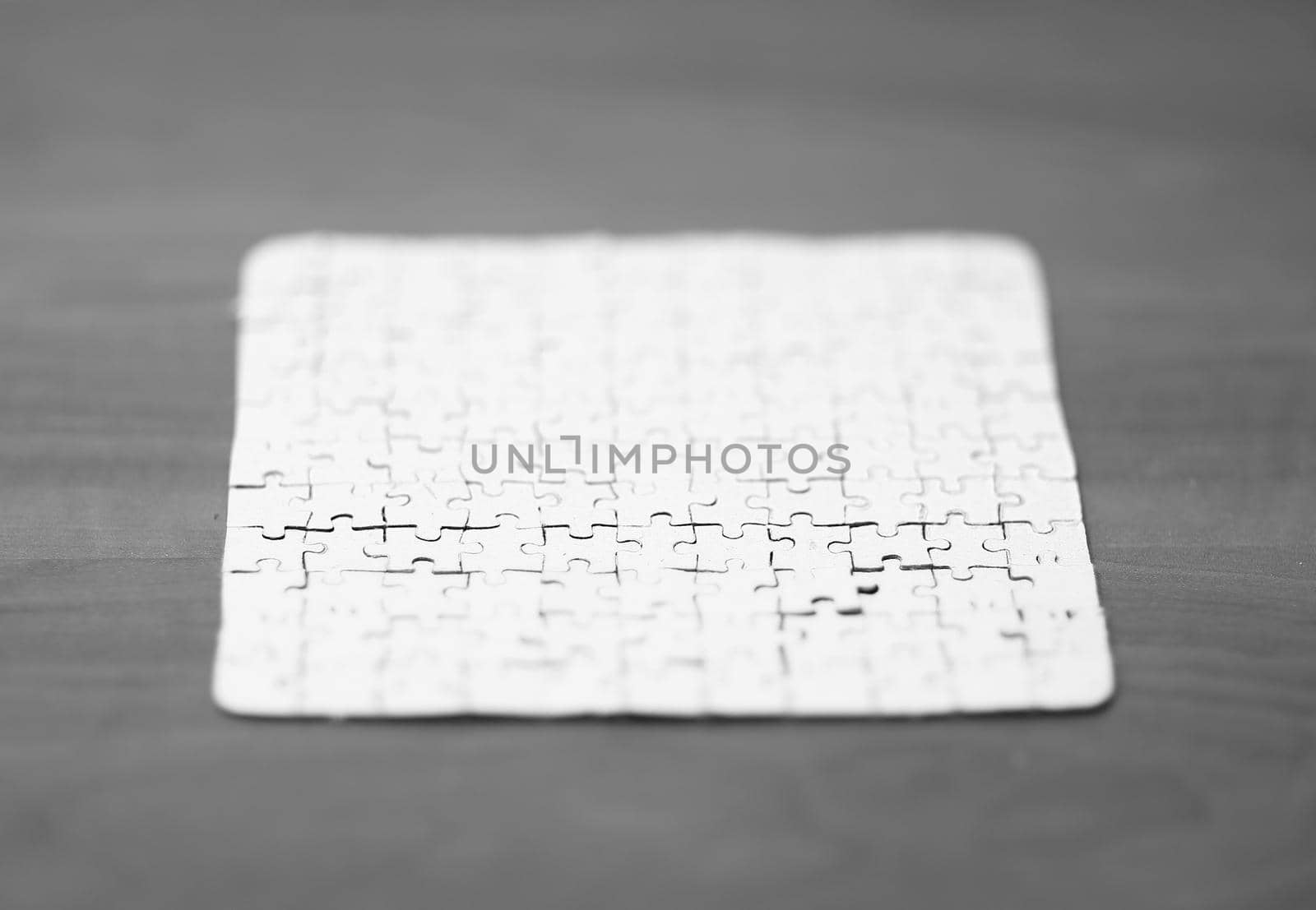 blank card collected from puzzle pieces on wooden background.