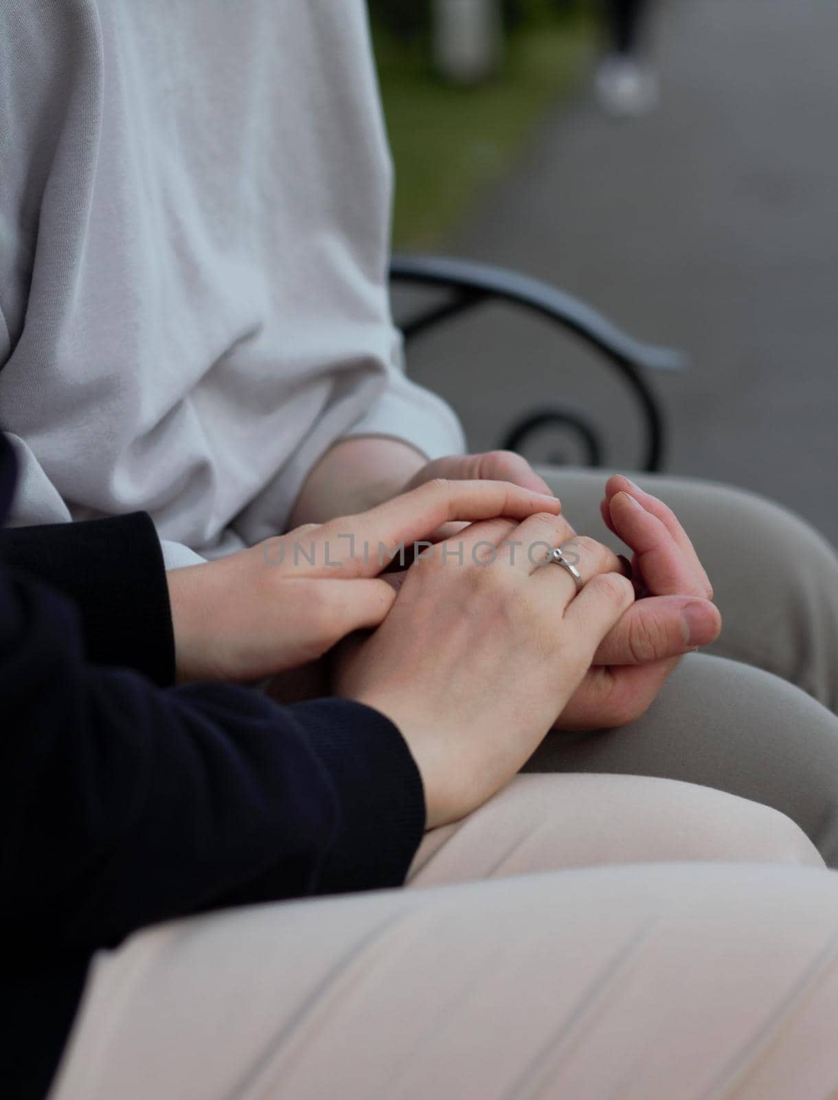 love concept - close up of engaged couple holding hands with ring by AleksandraLevkovskaya