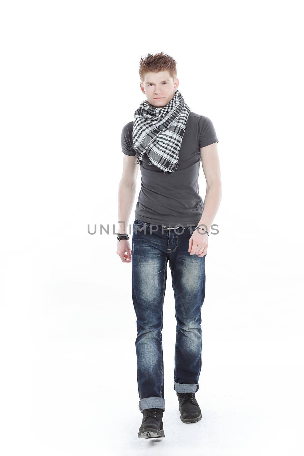 young man in a t-shirt and scarf ,confidently goes forward.isolated on a white background.