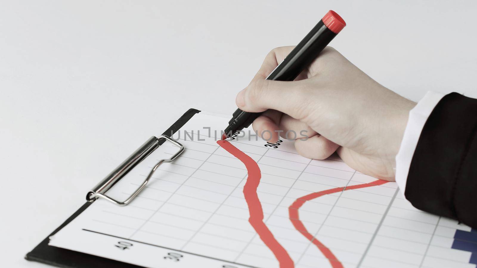 closeup .Businessman drawing a stock chart.isolated on white background