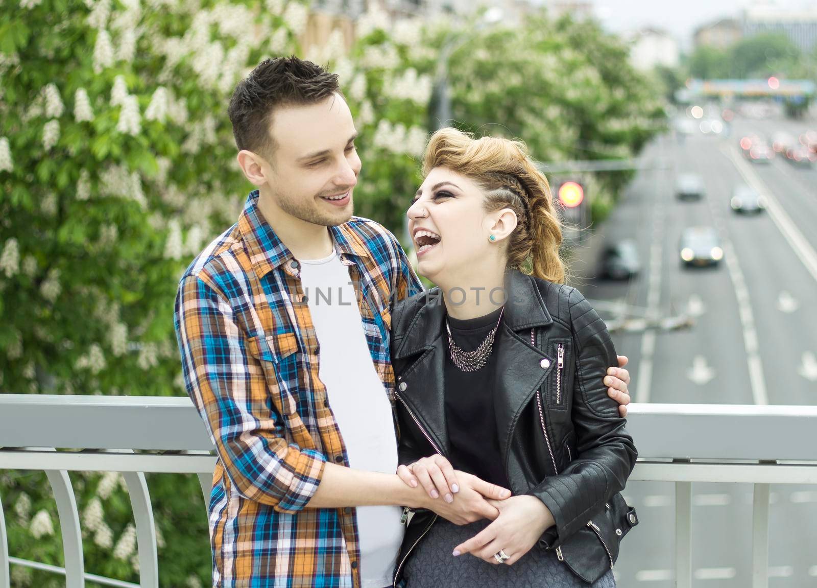 portrait of loving couple standing on bridge in big city by SmartPhotoLab