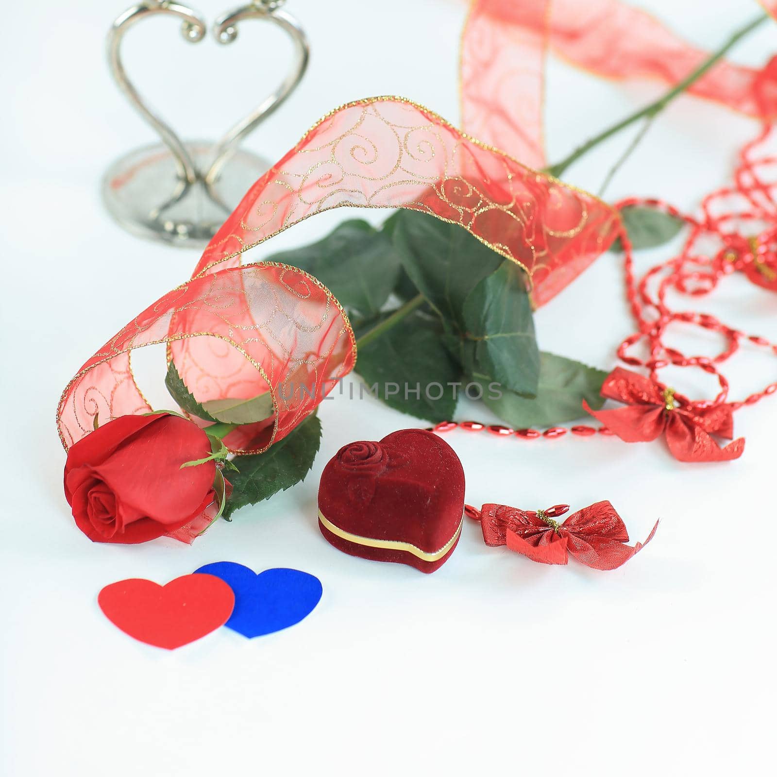 rose and a box with a ring on a Valentine's day card .photo with copy space.