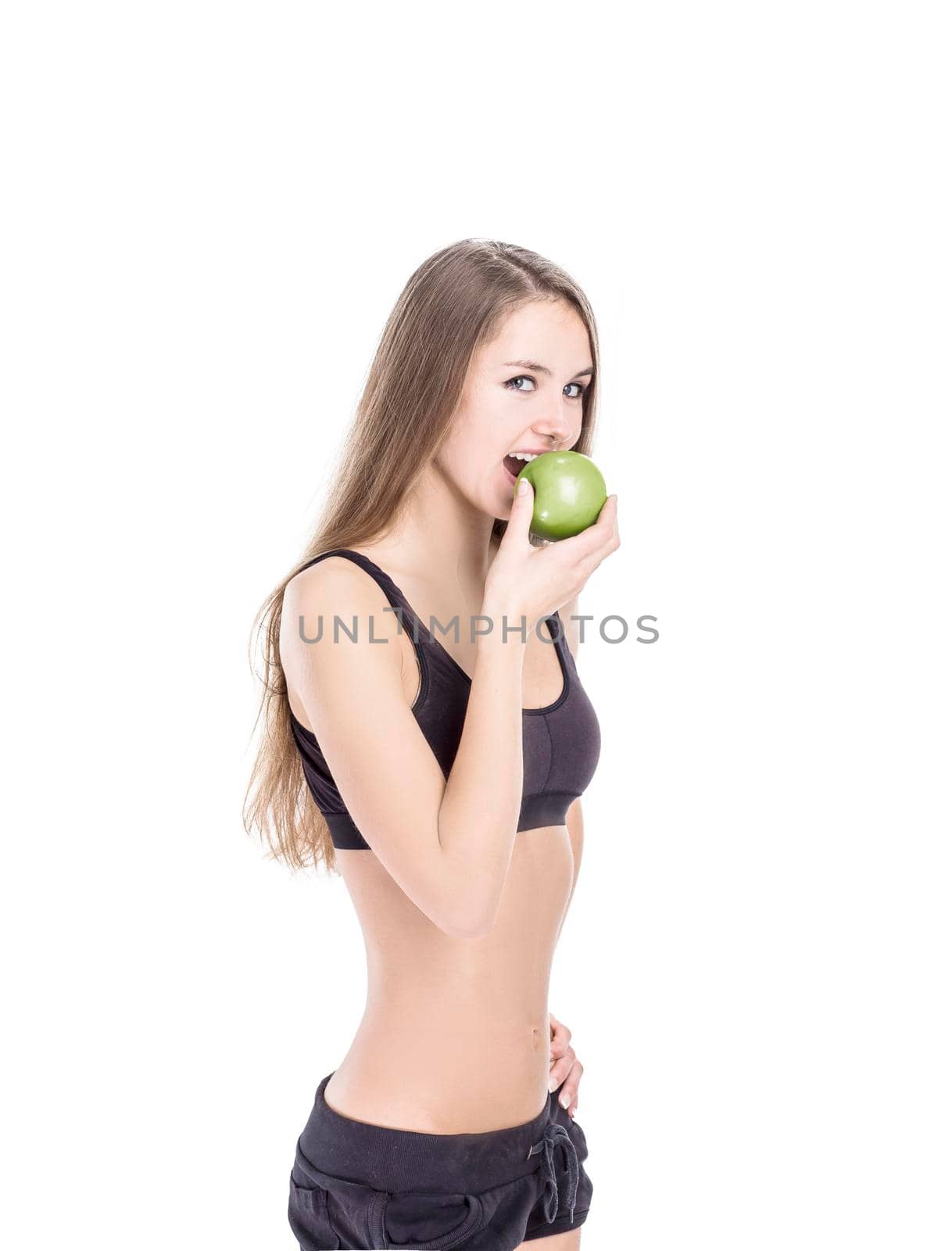concept of a healthy lifestyle: portrait of a female fitness instructor with an Apple in his hand by SmartPhotoLab