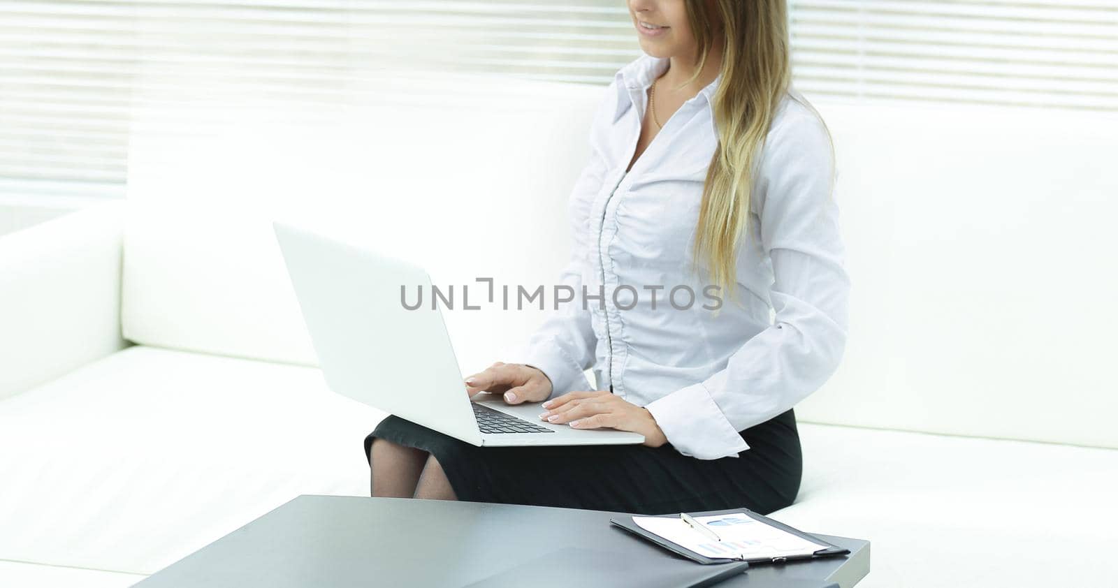 young business woman with laptop on the background of the office.photo with place for text