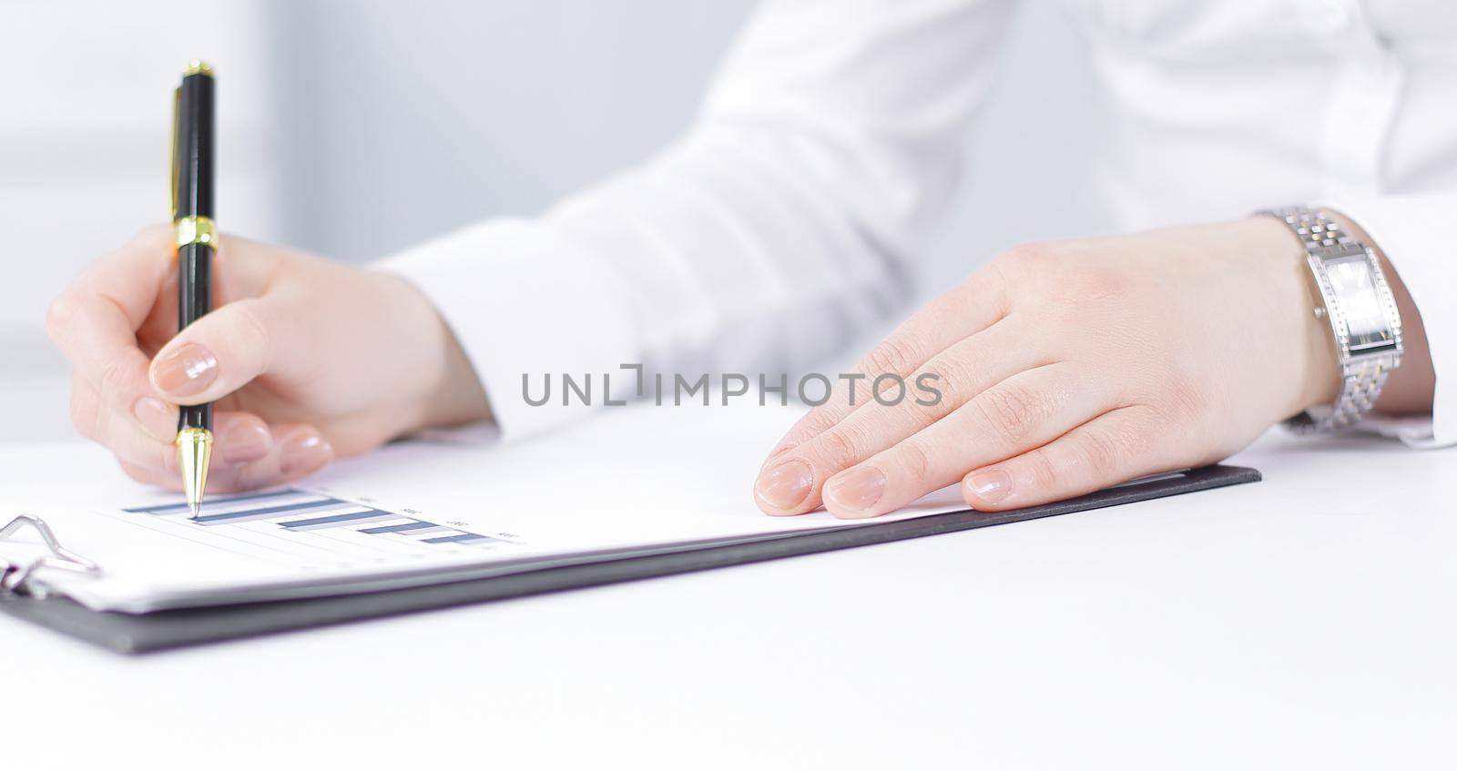 business woman analyzing the financial schedule by SmartPhotoLab
