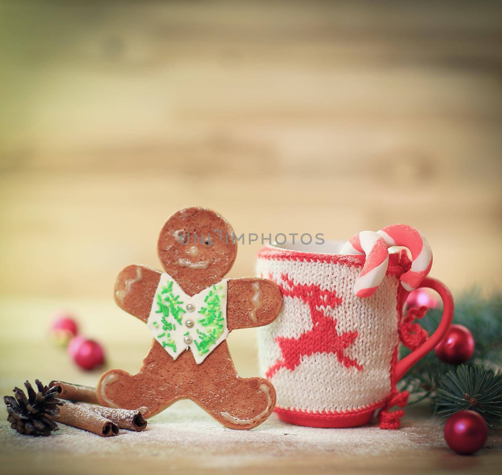 Christmas Cup ornament and a fun gingerbread on a wooden table .photo with copy space .