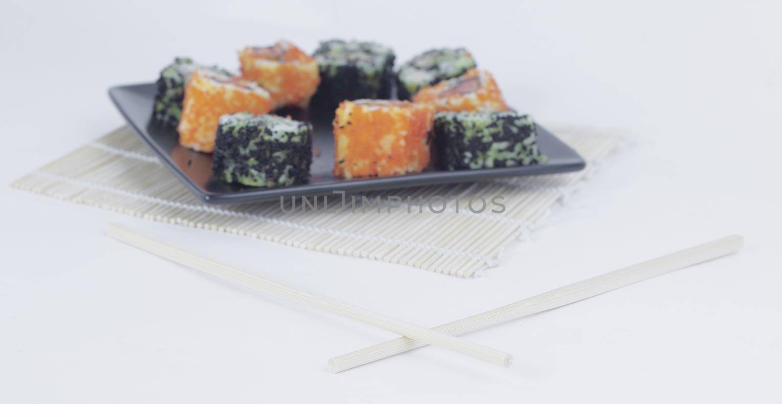 different types of Maki sushi on a black plate.isolated on white background