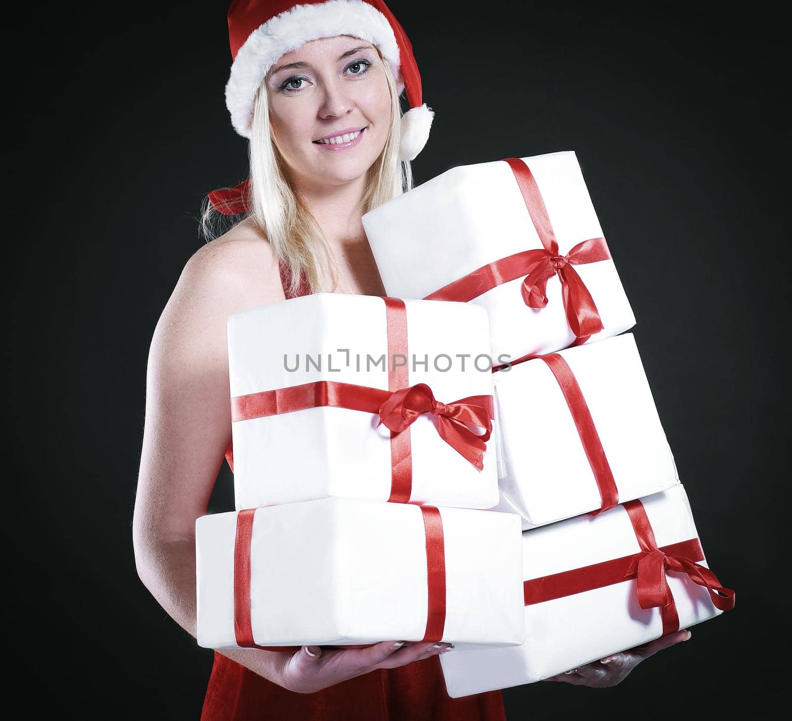 blonde woman in costume of Santa Claus with Christmas shopping. isolated on black.