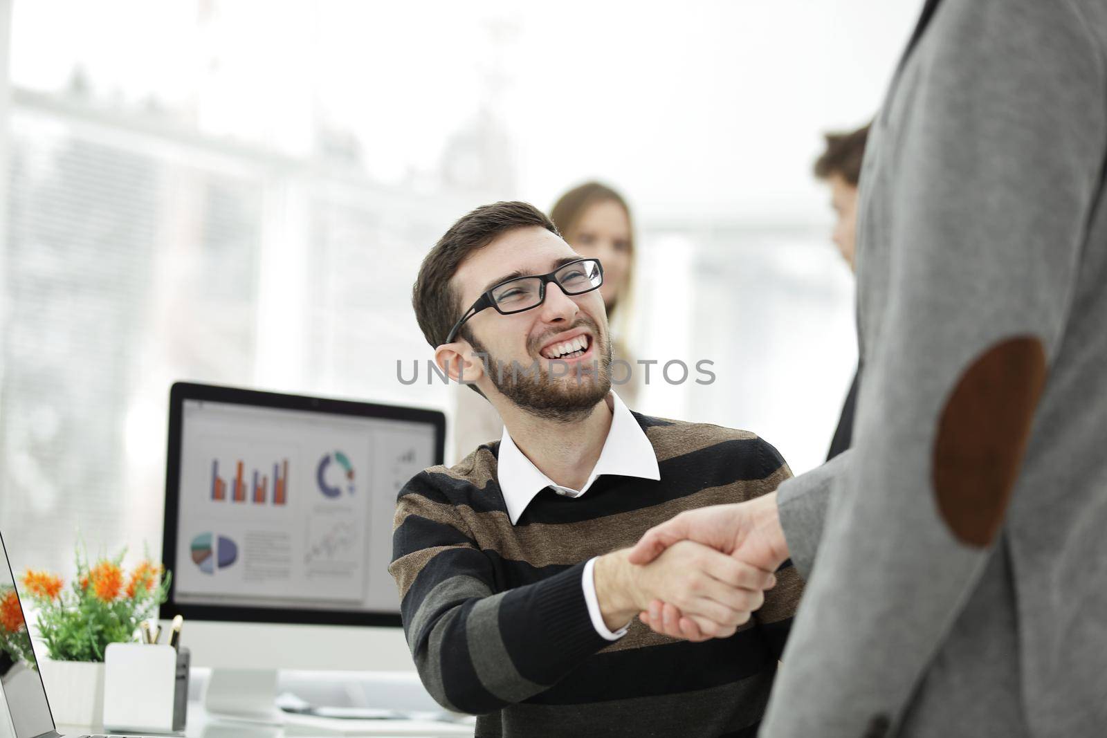 handshake Manager and client in the office. by SmartPhotoLab