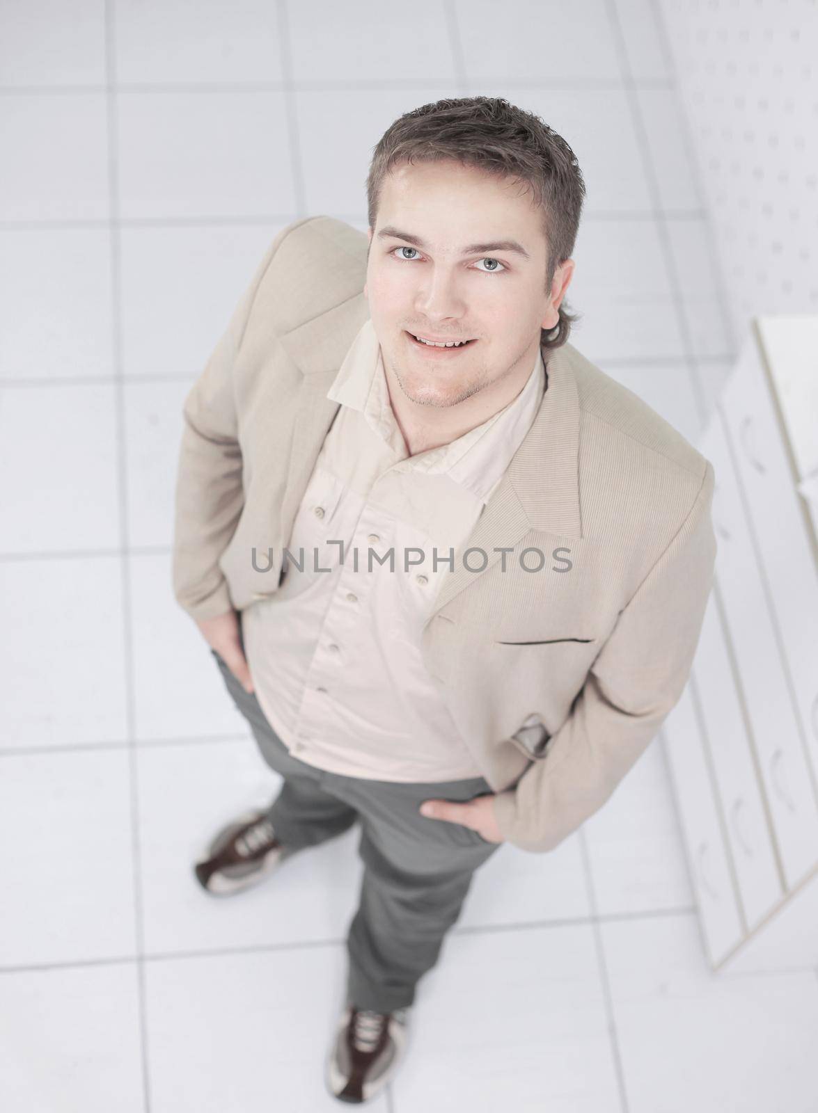 view from the top.confident young businessman looking at the camera.