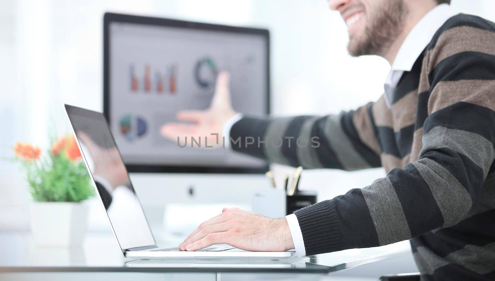 Businessman working with project statistics data, using laptop, analyzing financial graphs and charts