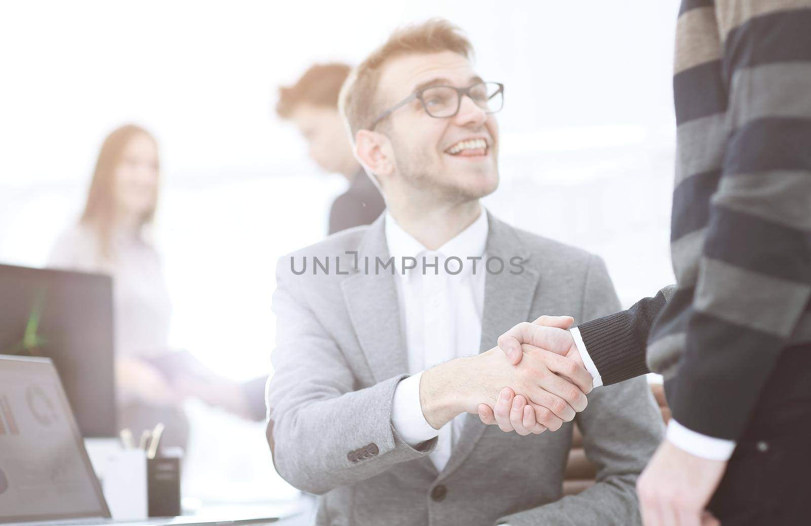 Manager and the client shake hands when meeting in the office.concept of partnership