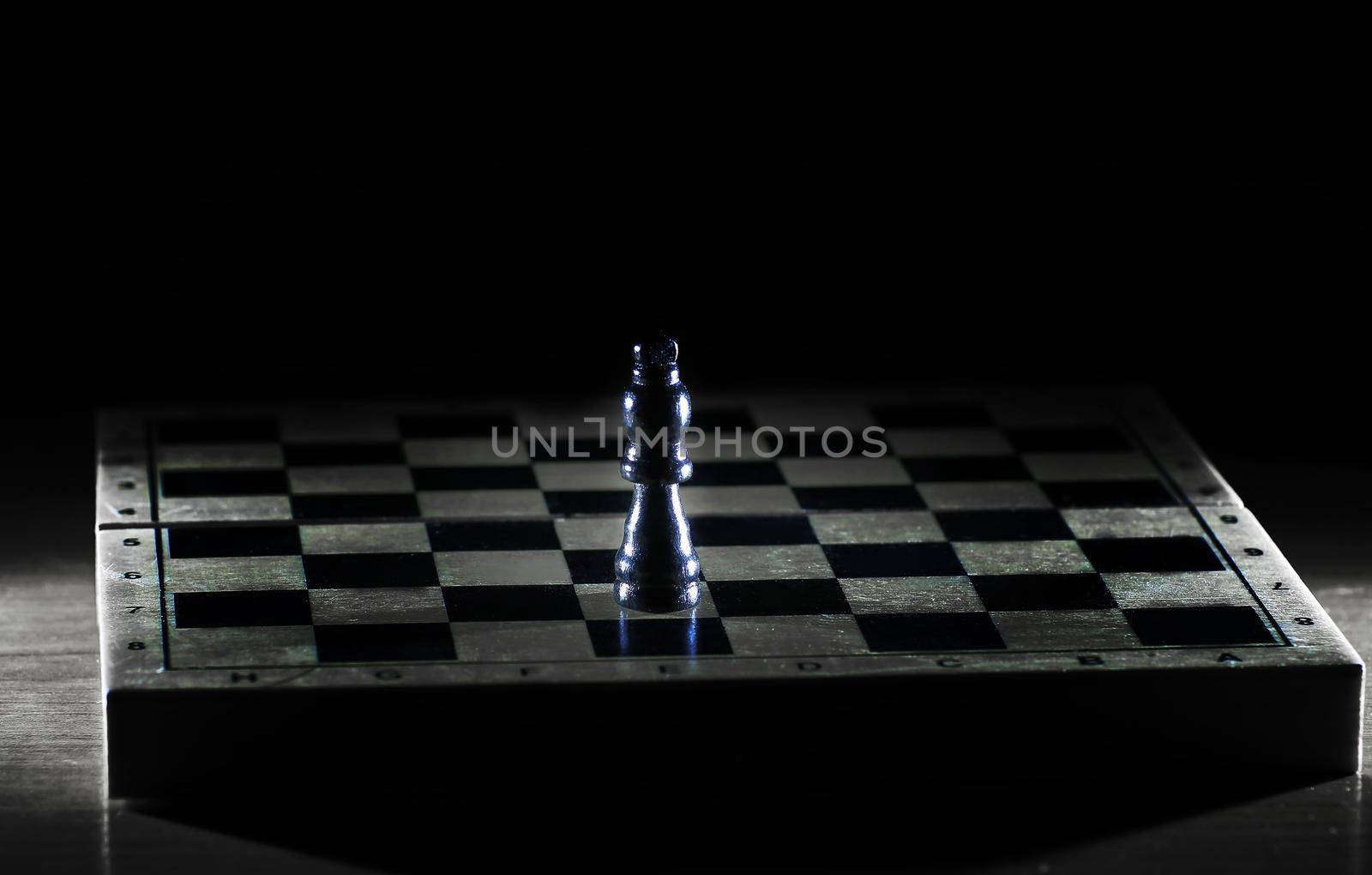 black king on a chessboard . photo with copy space by SmartPhotoLab